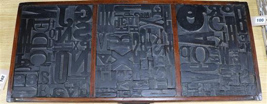 A framed collection of printing blocks 82cm wide x 36cm high